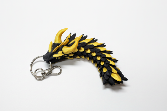 Black and yellow dragon keychain on white background